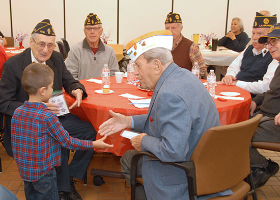 Township Superintendent Louis S. Viverito shakes hands with a young well wisher.